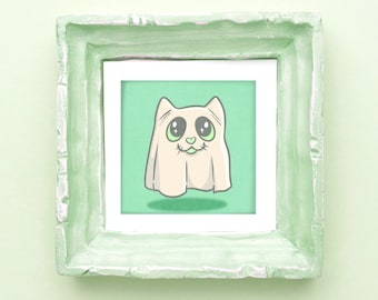 May include: A framed print of a cartoon ghost cat with big eyes and a heart-shaped nose. The artwork is set against a light green background and framed in a square, distressed, pale green frame. The image has a whimsical and playful style.
