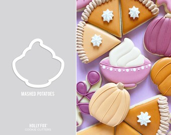May include: A set of cookie cutters featuring various Thanksgiving themes, including a pumpkin, a pie, and a bowl of mashed potatoes. The cutters are made of metal and have a silver finish. The text "HOLLY FOX COOKIE CUTTERS" is printed on the bottom of the image.