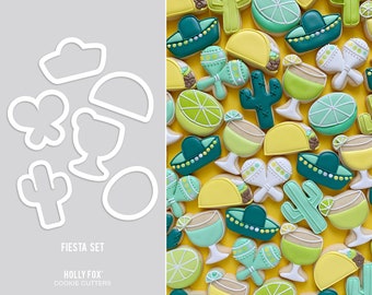 May include: A collection of fiesta-themed cookies and cookie cutters. The cookies are decorated with vibrant colors and designs, including sombreros, tacos, maracas, and cacti. The cookie cutters are white and include shapes like a cloud, butterfly, and cactus. The text "FIESTA SET" is visible.