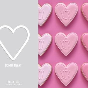 May include: A set of nine pink and white heart-shaped cookies with the text "XOX" on each cookie. The cookies are arranged in a grid pattern on a pink background. The image also shows a white outline of a heart-shaped cookie cutter.
