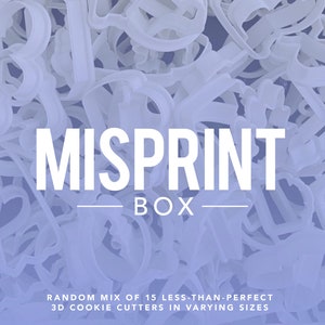 May include: A box of 15 misprint 3D cookie cutters in varying sizes. The box is labeled "MISPRINT BOX" and "RANDOM MIX OF 15 LESS-THAN-PERFECT 3D COOKIE CUTTERS IN VARYING SIZES".
