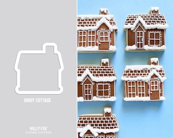 May include: Five gingerbread house cookie cutters, each with a different design. The cutters are made of metal and have a white outline. The text "Gingy Cottage" is printed below the cutters.