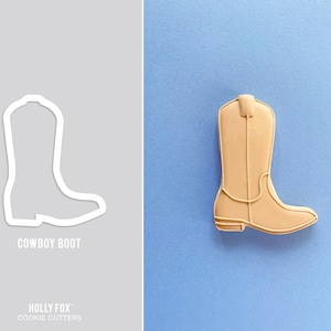 May include: A brown cowboy boot cookie cutter. The cutter is made of metal and has a detailed design. The cutter is shown on a light blue background.