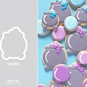 May include: A set of purple and gray cauldron cookie cutters with a white outline. The cutters are shaped like cauldrons with a handle and a rounded base. The cutters are arranged in a circle on a light blue background.