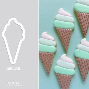 May include: A white metal swirl cone cookie cutter next to decorated ice cream cone cookies. The cookies have a brown waffle cone, mint green and light pink frosting. The text "SWIRL CONE" and "HOLLY FOX COOKIE CUTTERS" are also visible.