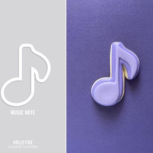 May include: A purple music note cookie cutter. The cutter is shaped like a musical note with a rounded head and a long stem. The text "MUSIC NOTE" is printed below the cutter.