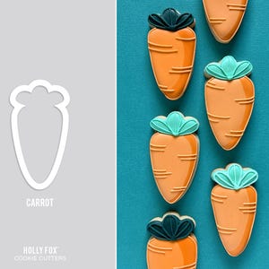May include: Orange carrot-shaped biscuits with green and dark green accents are arranged on a teal background. A white carrot-shaped cookie cutter is on the left. The word "CARROT" is below the cutter. "HOLLY FOX COOKIE CUTTERS" is below the word "CARROT".