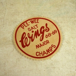 May include: A brown and red circular patch with the text "Pee-Wee Galt's Wings 68-69 Major Champs" in red lettering.
