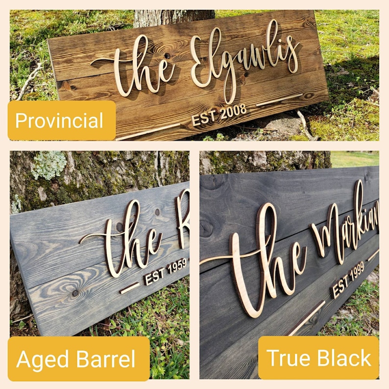 May include: Three wooden signs with different wood stains. The signs are all the same size and shape. The top sign is stained a dark brown color and says "the Elguulas EST 2008". The middle sign is stained a light gray color and says "the R EST 1959". The bottom sign is stained a dark black color and says "the Markin EST 1999".