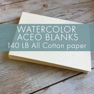 May include: A stack of watercolor ACEO blanks made of 140 lb all cotton paper. The paper is a bright white color and has a textured surface. The text "WATERCOLOR ACEO BLANKS 140 LB All Cotton paper" is displayed on the image.