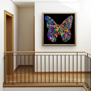 May include: A framed artwork featuring a colorful butterfly made of smaller butterflies. The butterfly is set against a black background and is framed in a gold frame.