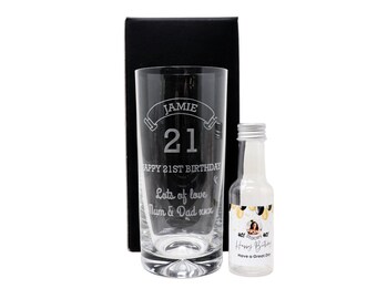 May include: A personalized tall glass with the name Jamie and the number 21 engraved on it. The glass is in a black box with a small bottle of liquor that says "Happy Birthday".