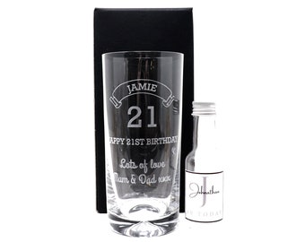 May include: A personalized glass with the name Jamie and the number 21 etched on it. The glass is in a black box with a small bottle of alcohol. The text on the glass reads "Happy 21st Birthday Lots of love Mum & Dad xxx".