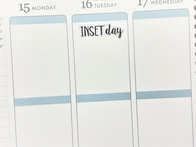 May include: A planner page with the days of the week, Monday, Tuesday, and Wednesday. A sticker with the words "INSET day" is placed on the Tuesday section. The planner has a white background with light blue accents.