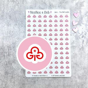 May include: A sheet of stickers with a pink background and a white border. The stickers feature a red trefoil design with a star in the center. The sheet includes 364 stickers and is titled "364 Trefoil Guide". The text "NooNoo & Bob" is also included on the sheet.