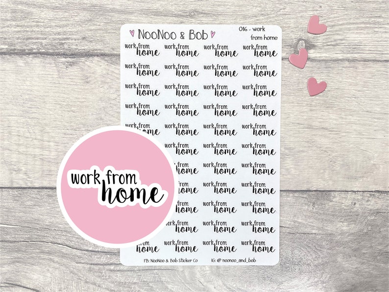 May include: A sheet of pink and white stickers with the text "work from home" repeated multiple times in black cursive font. The stickers are arranged in a grid pattern. There are also three pink hearts on the sheet.