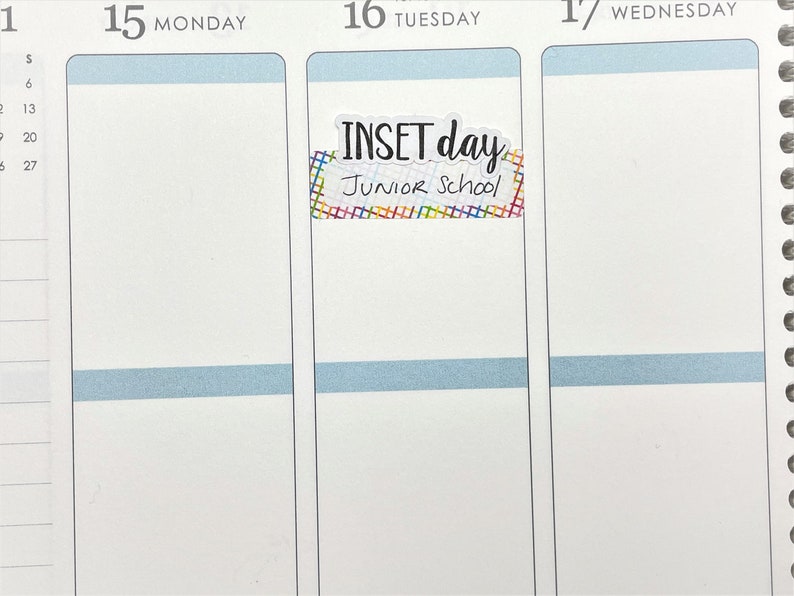 May include: A planner page with the date 15 Monday at the top. A sticker with the text "INSET day Junior School" is placed in the center of the page. The sticker has a colorful grid pattern.