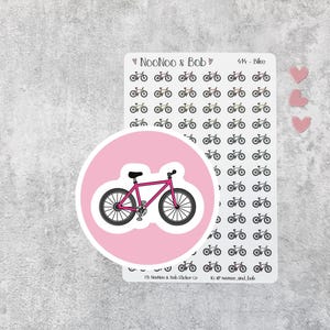 May include: A sheet of stickers featuring bicycle designs, a pink bicycle sticker, and three pink heart stickers. The bicycle stickers are black and white. The pink bicycle sticker has a pink background and a magenta bicycle.