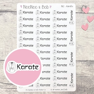 May include: A sheet of pink and white stickers with a karate uniform design and the word "Karate" repeated multiple times. The stickers are designed for use in a planner or journal.