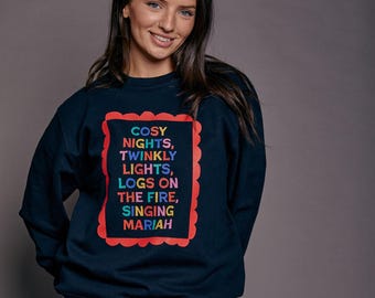 Sudadera navideña con el lema "Noches Acogedoras"