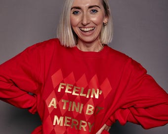 Sudadera navideña con el lema "Feelin' A Tini Bit Merry"