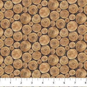 May include: A fabric featuring a repeating pattern of wood cross-sections in shades of brown and tan. The circular shapes vary in size and are set against a dark grey background. A ruler is visible at the bottom.