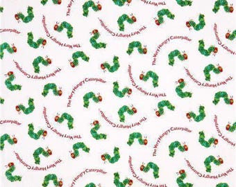 Puede incluir: Una tela blanca con un patrón repetitivo de La oruga muy hambrienta. El diseño incluye múltiples orugas verdes y amarillas con cabezas rojas, intercaladas con el texto The Very Hungry Caterpillar en color rojo.