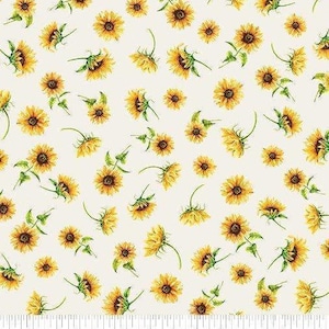 May include: A cream-colored fabric featuring a repeating pattern of yellow sunflowers with green stems and leaves. A white ruler at the bottom edge shows a scale of 7 inches, with the text Benartex printed near the center mark.