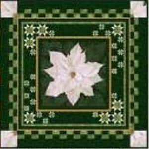 May include: A square quilt featuring a central white poinsettia flower on a dark green background. The border consists of a checkered pattern in shades of green, accented with small white star motifs and white corner squares.