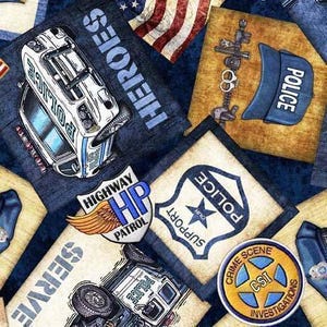 May include: A fabric print featuring police-themed graphics including a white police car with the text HEROES, a blue police cap, a Highway Patrol badge with wings, a Support Our Police shield, and a circular Crime Scene Investigations badge.