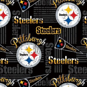 May include: A black fabric pattern featuring the Pittsburgh Steelers logo in white circles with yellow, red, and blue stars. The design includes the word Steelers in yellow and white, and Pittsburgh in yellow script, alongside triangular pennants.