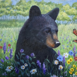 May include: An oil painting of a black bear cub sitting in a vibrant meadow filled with colorful wildflowers including blue, white, yellow, and red blossoms. Two orange and black monarch butterflies fly near the bear's head.
