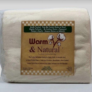 May include: A rectangular package of off-white Warm & Natural needled cotton batting wrapped in clear plastic. The label features a brown background with a checkered border, a cotton plant illustration, and text stating 3.04m x 3.15m.