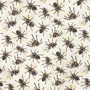 May include: A white fabric featuring a repeating pattern of brown and black tarantulas positioned over a light gold spiderweb design. The textile displays multiple arachnids in various orientations across the entire surface area.