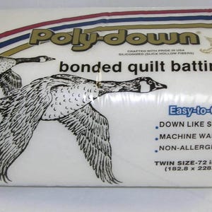 May include: A package of white Poly-Down bonded quilt batting featuring a graphic of two flying geese. The packaging includes the text Easy-to-Quilt, down like softness, machine washable, non-allergenic, and twin size 72 in. x 90 in.