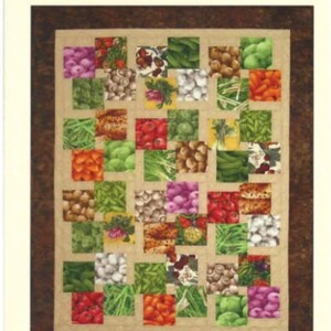 May include: A quilt pattern titled I Spy a Veggie Stir Fry by Quilt Chef, featuring a grid of square fabric blocks displaying various vegetables like tomatoes, onions, mushrooms, and greens, framed by a dark brown border on a light background.