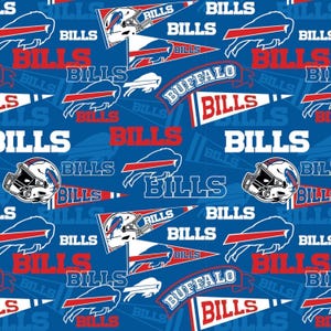 May include: A blue fabric pattern featuring the Buffalo Bills logo, football helmets, and pennants with the text Bills and Buffalo. The design includes repeating white and red graphics of the team name and symbols set against a solid blue background.