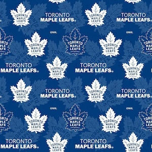 May include: A blue fabric featuring a repeating pattern of the white Toronto Maple Leafs logo, which consists of a maple leaf shape with the text Toronto Maple Leafs inside. The design includes subtle, darker blue leaf silhouettes and NHL text.