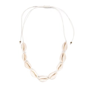 May include: A white shell necklace with a white cord and a simple knot closure. The necklace is made of cowrie shells.