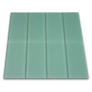 May include: A light green rectangular bar of soap with a raised design of vertical and horizontal lines.