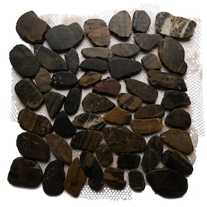 May include: A collection of smooth, dark-colored river stones of various shapes and sizes. The stones have a mix of brown, gray, and black hues, with some showing striped patterns. They are arranged on a white mesh backing.