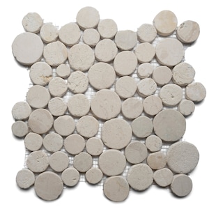 May include: A mosaic tile sheet featuring numerous beige, circular stones of varying sizes. The stones are arranged closely together and mounted on a mesh backing. The natural stone has a slightly rough texture and a neutral color palette.
