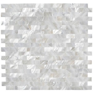 May include: White iridescent mother of pearl tile sheet. The tiles are arranged in a brick pattern. The tiles are small and rectangular.