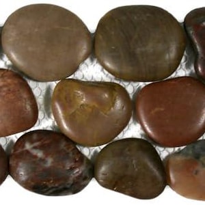 May include: A collection of smooth, polished river rocks in various shades of brown, tan, and reddish-brown. The stones are oval and rounded, with a natural, earthy appearance. The arrangement suggests a decorative or landscaping element.