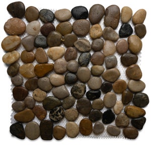 May include: A sheet of natural stone pebbles in various shades of brown, beige, and gray, arranged in a mosaic pattern on a white mesh backing.