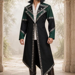 May include: A long black and dark green coat featuring silver metallic embroidery along the lapels, cuffs, and hem. The coat has a high collar, a single front button closure, and a delicate silver chain detail connecting the lapels at the chest.