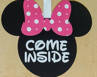 May include: Black and pink Minnie Mouse-themed door hanger with white polka dots and the text "COME INSIDE".