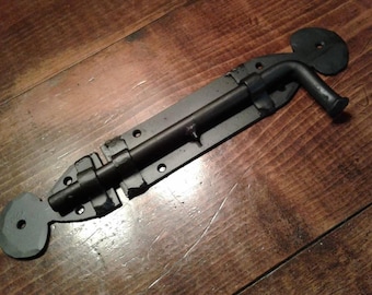 Heavy duty lockable sliding bolt latch with spade motif.