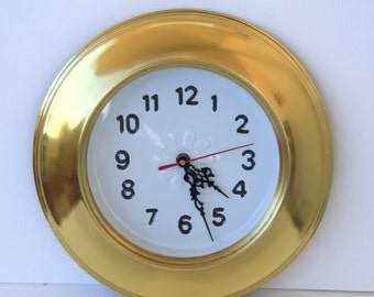 Brass clock to hang on the wall.