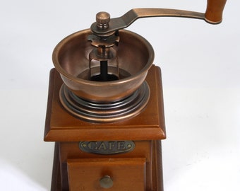 Coffee grinder in wood and copper. Coffee grinder